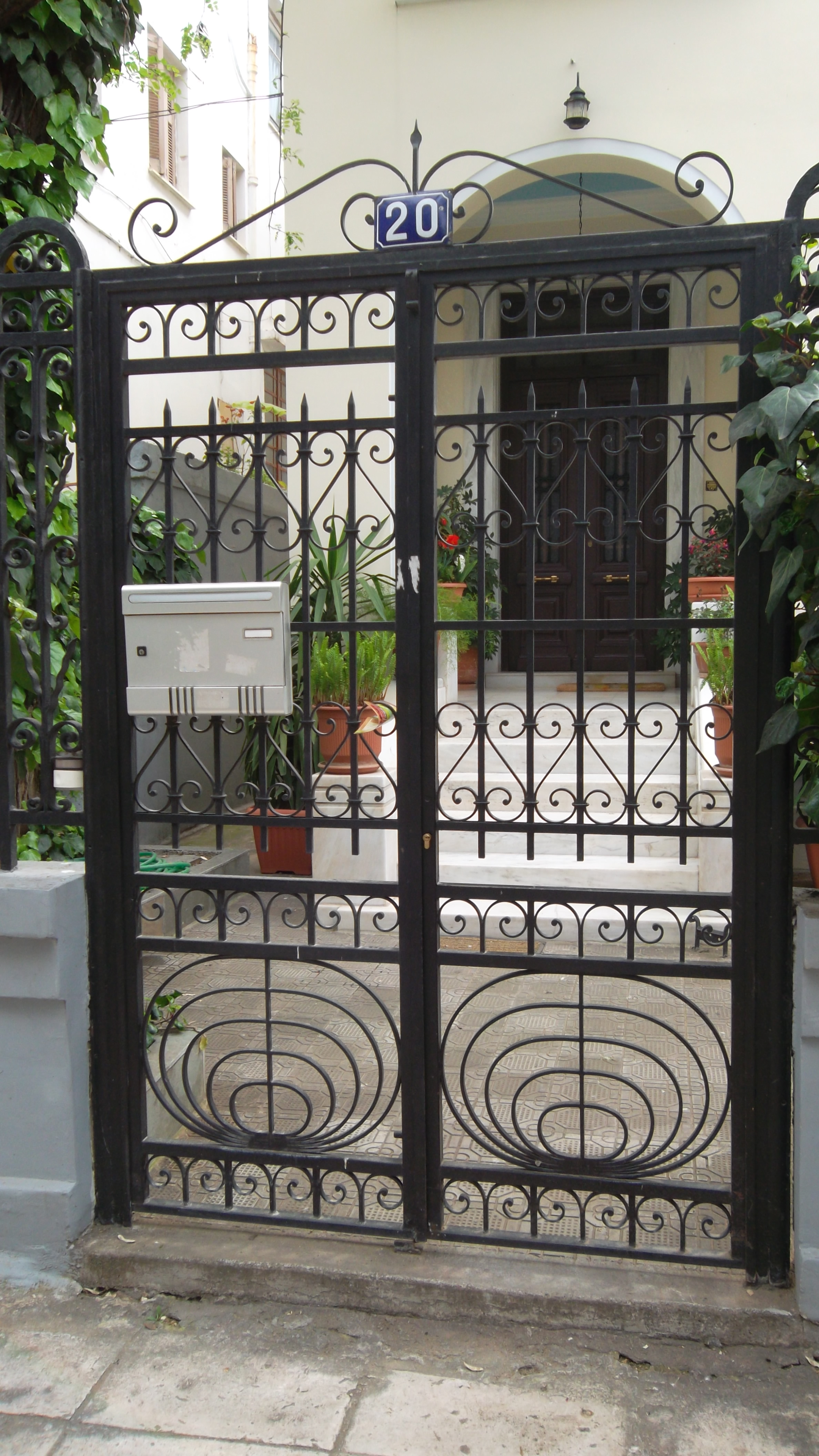 Metallic front yard door. Front yard and entrance view.